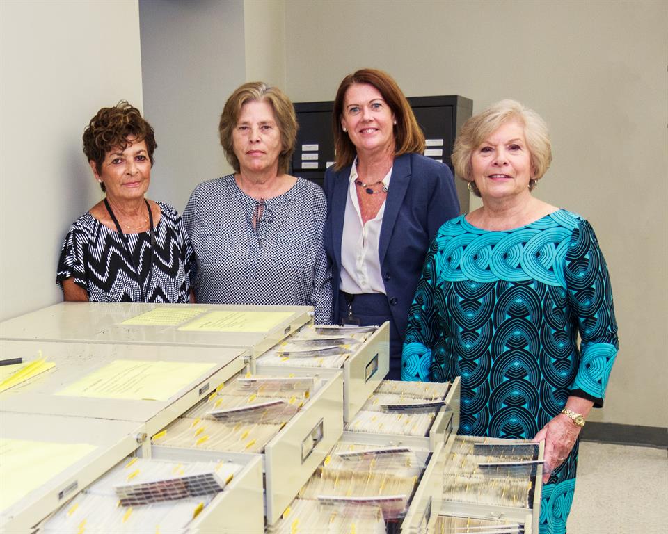 Monmouth County Surrogate’s Office is set to digitize 80,000+ microfiche records. Some of the records are shown here in the open file drawers containing the fiche that will be converted. From left:  Records Room staff Geri Grimaldi and Pat Carlson, manager; Patty Coyne, Deputy Surrogate, and Monmouth County Surrogate Rosemarie Peters. 